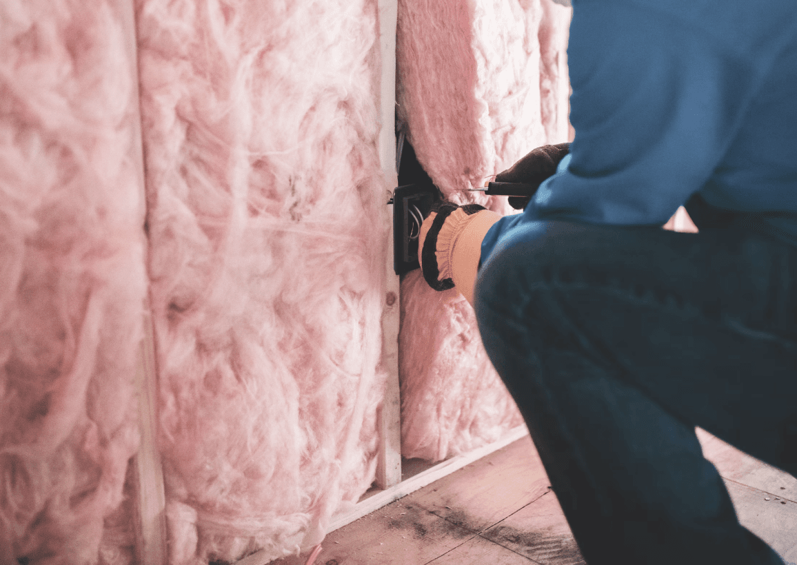 man installing insulation